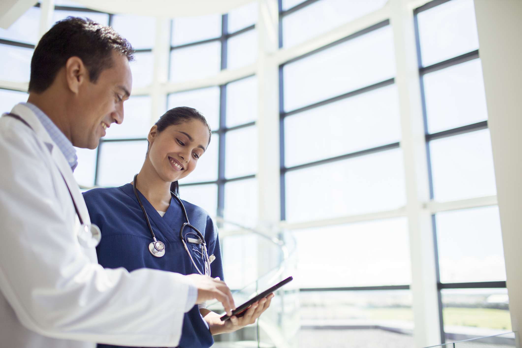 Doctor and nurse reading medical chart in hospital